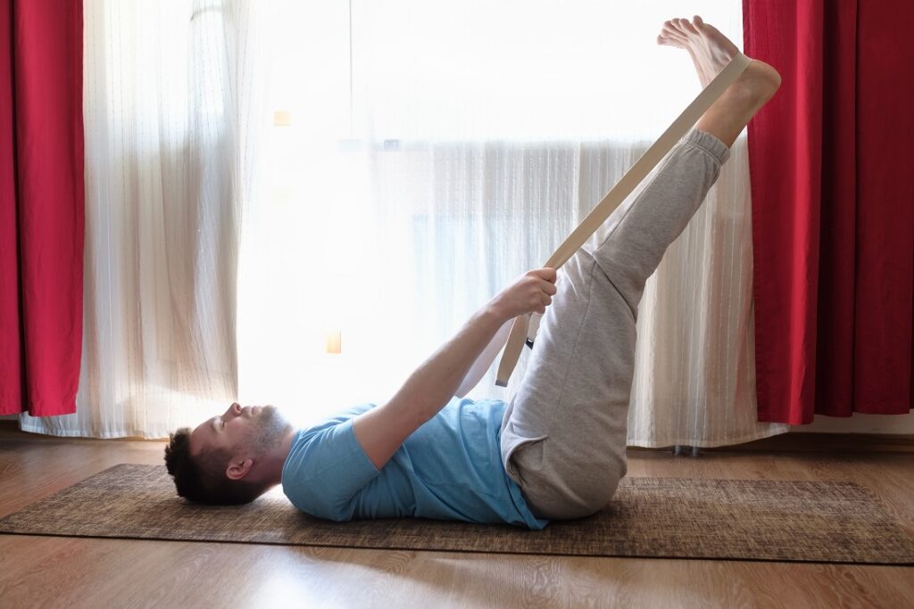 caucasian man in yoga pose laying